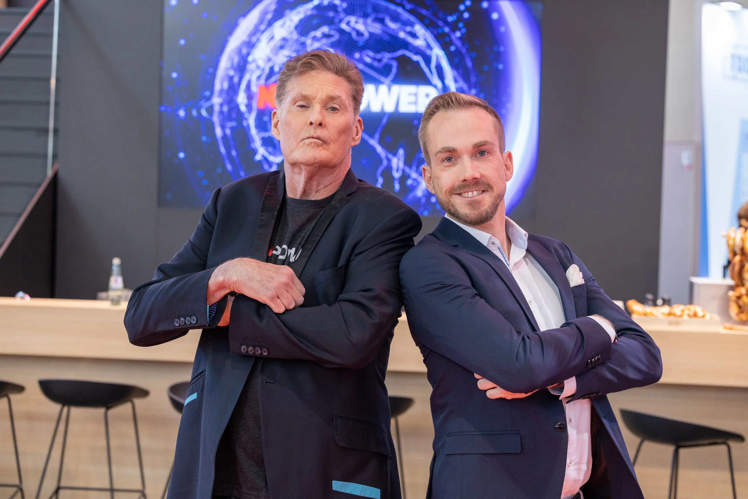 Event host Felix Uhlig with David Hasselhoff at the NewPower stand at Electronica 2022 in Munich