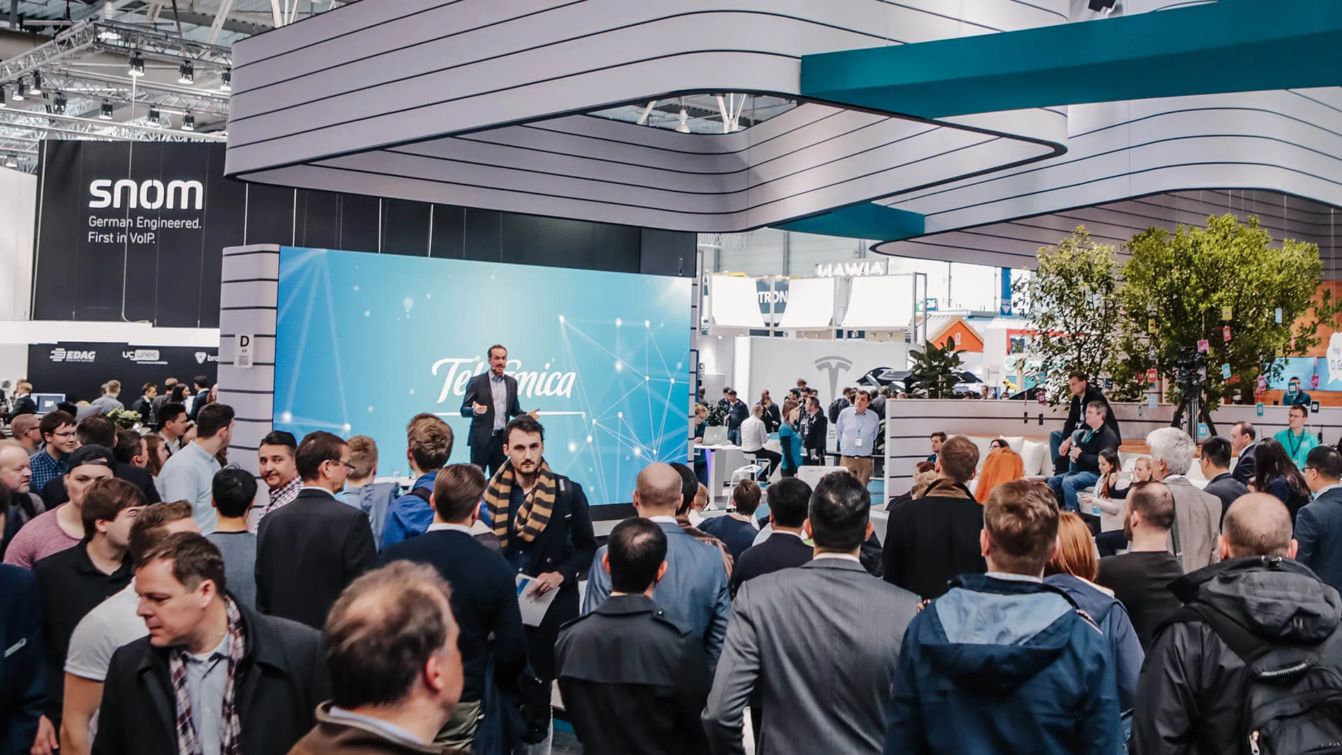 Trade show host Felix Uhlig on the Telefónica stand stage at CEBIT in Hanover in front of a densely packed audience