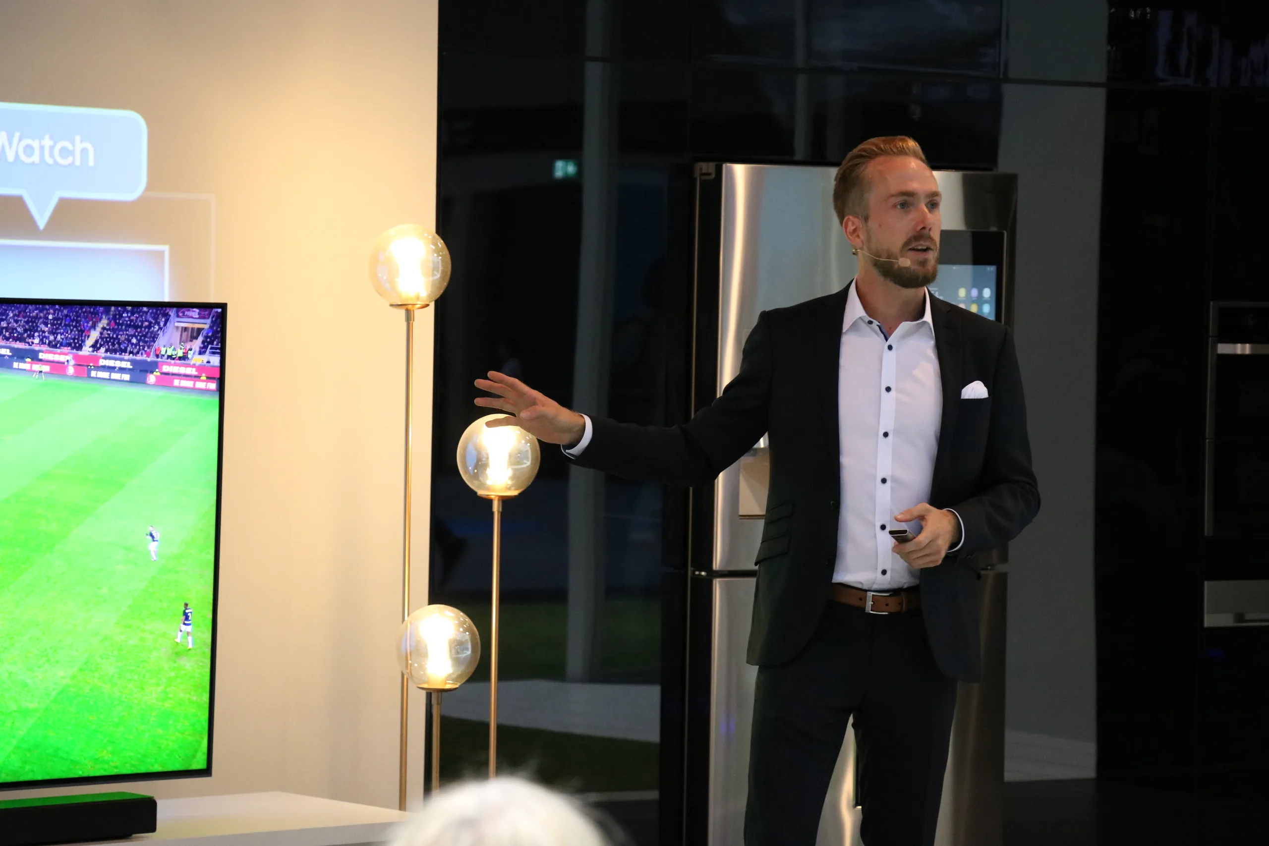 Host Felix Uhlig in front of a Samsung smart TV in the living room setup at IFA 2018 in Berlin