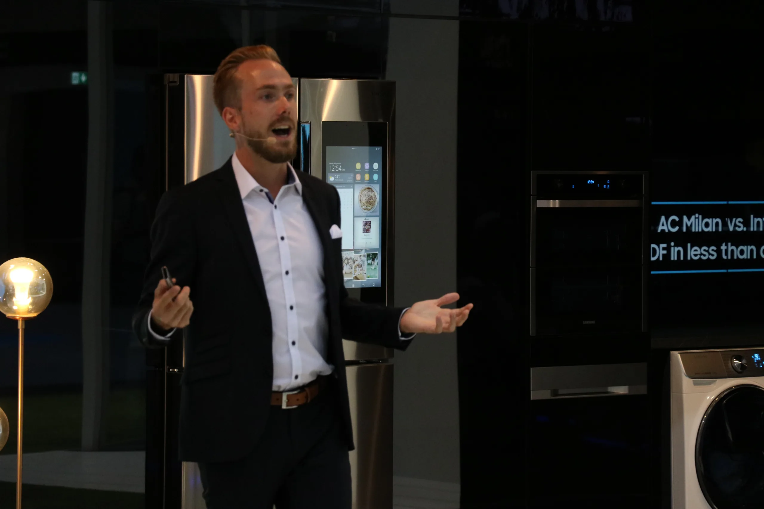 Host Felix Uhlig next to a connected Samsung fridge at IFA 2018 in Berlin