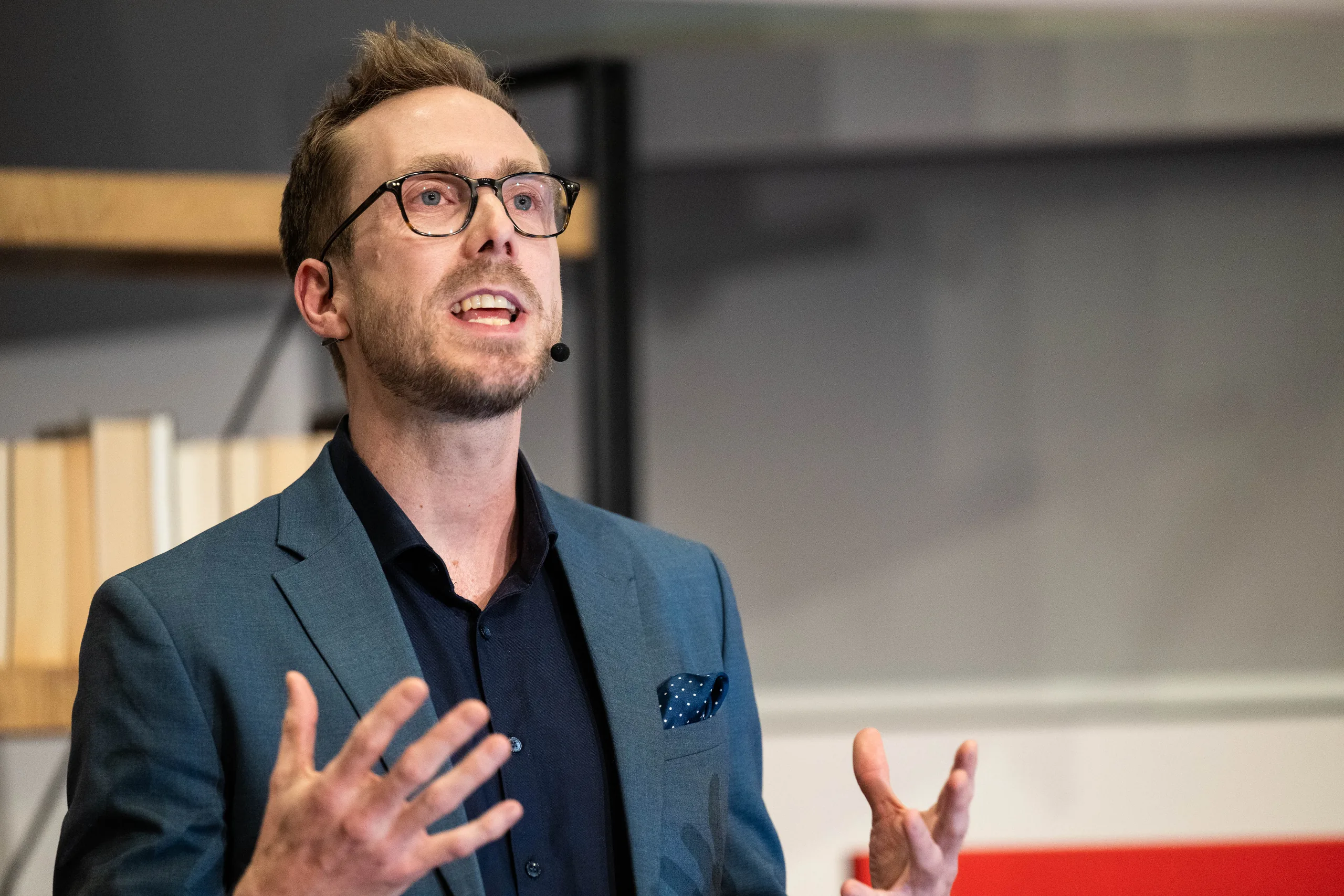 Moderator Felix Uhlig gestikulierend in der Nahaufnahme bei TEDxKLU Hamburg
