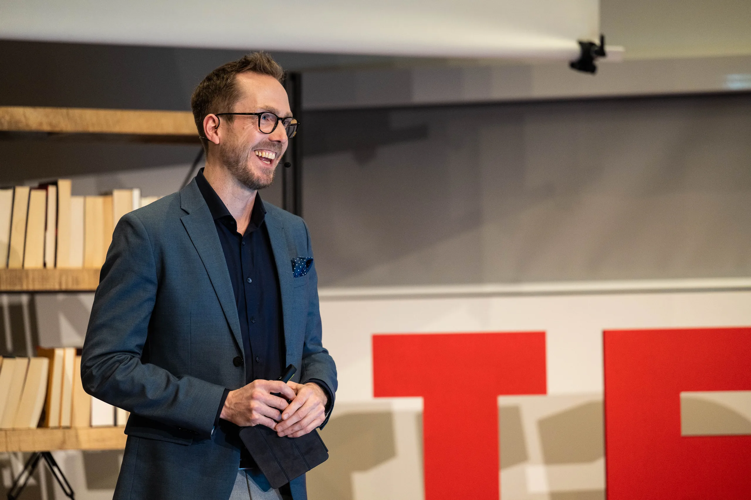Event host Felix Uhlig on stage at TEDx at Kühne Logistics University in Hamburg